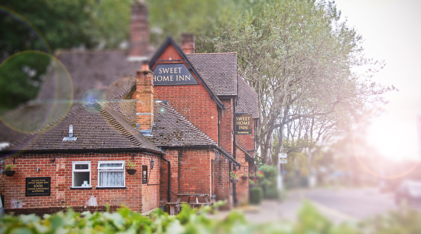 External red brick wall with Sweet Home Inn writing